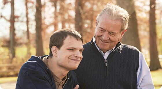 Patient living with LGS | Two Men Smiling in Wooded Area